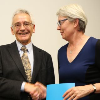 Centenary Professor John Dryzek accepts his award from DVC R&I Frances Shannon